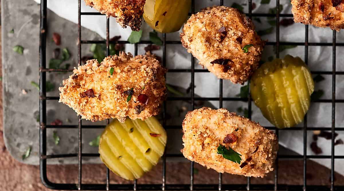 Air Fryer Chicken Nuggets on cooling rack with pickles