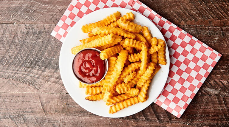plate of air fryer frozen french fries on plate with ketchup above
