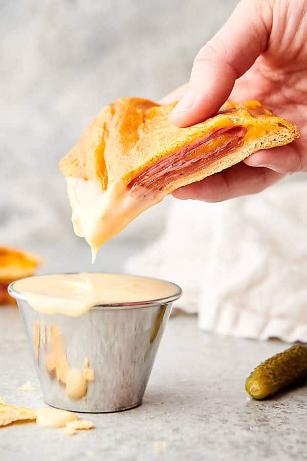 air fryer hot pocket being dipped in sauce