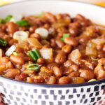 bowl of bbq baked beans held two hands