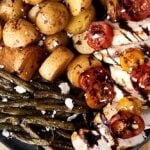 bruschetta chicken on plate with potatoes and green beans above