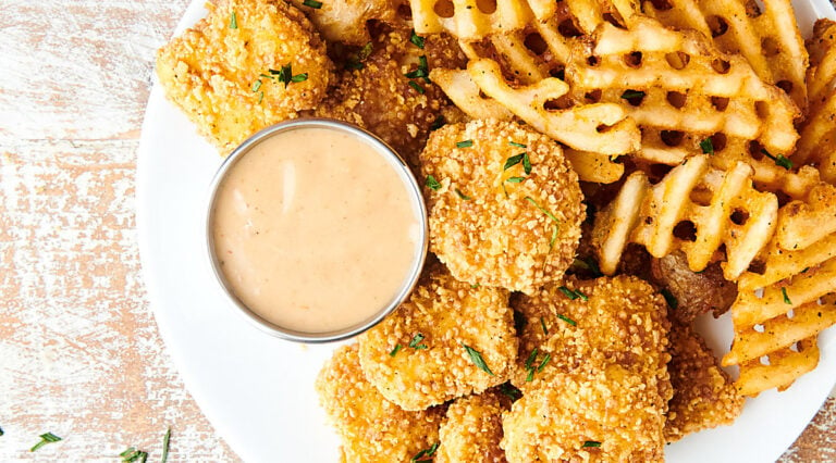 chick fil a sauce on plate with fries and chicken above