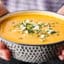 bowl of instant pot butternut squash soup held two hands
