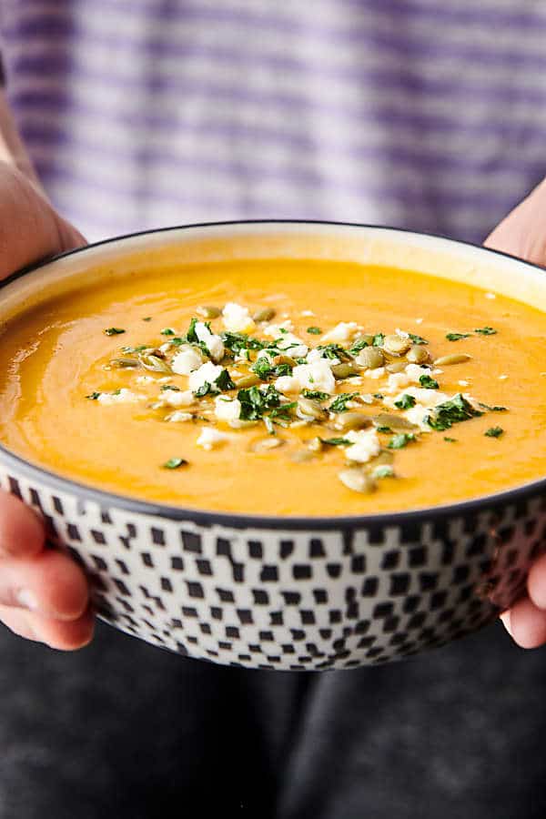 bowl of instant pot butternut squash soup held two hands