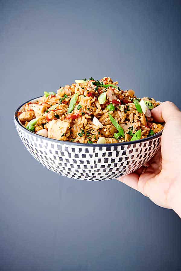 bowl of instant pot chicken fried rice held one hand