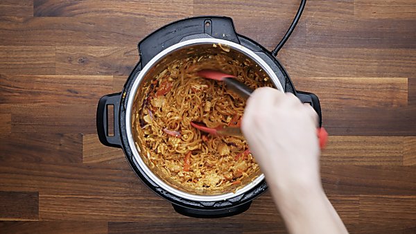 finished instant pot pad thai being served with tongs