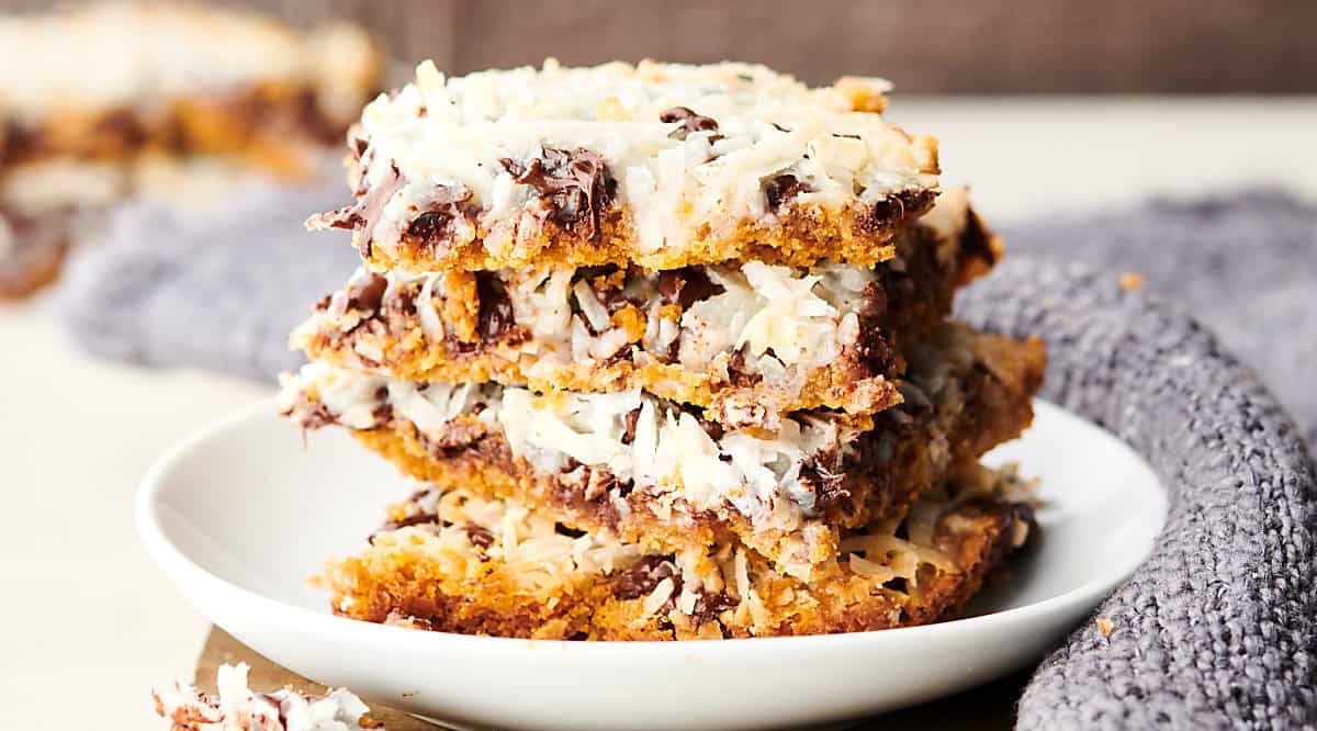 magic cookie bars stacked on plate