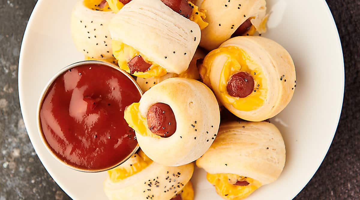 pigs in a blanket on plate with ketchup above