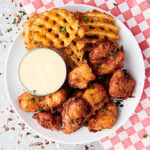 popcorn chicken on plate with fries above