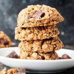 four vegan oatmeal cookies stacked on plate