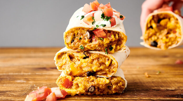three halves vegetarian breakfast burritos stacked