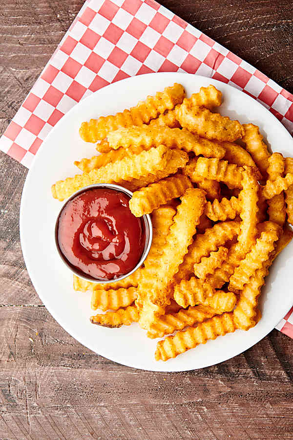 plate of air fryer frozen french fries with ketchup above