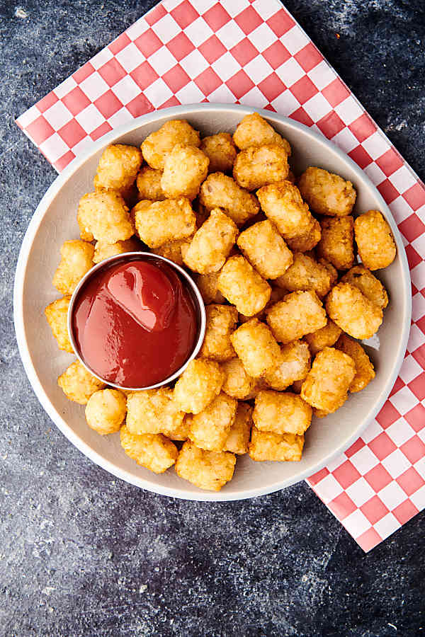 plate of air fryer tater tots with ketchup above