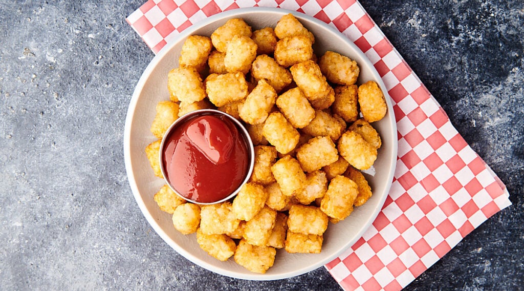 plate of air fryer tater tots with ketchup above