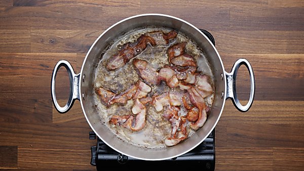 bacon being cooked in stockpot