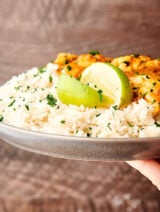 plate of coconut lime rice with chicken held