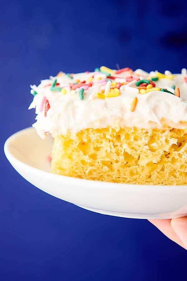 slice of cake on plate held