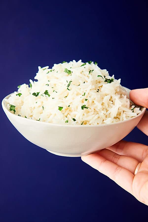 bowl of instant pot basmati rice held one hand