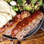 air fryer meatloaf on plate with mashed potatoes and broccoli above