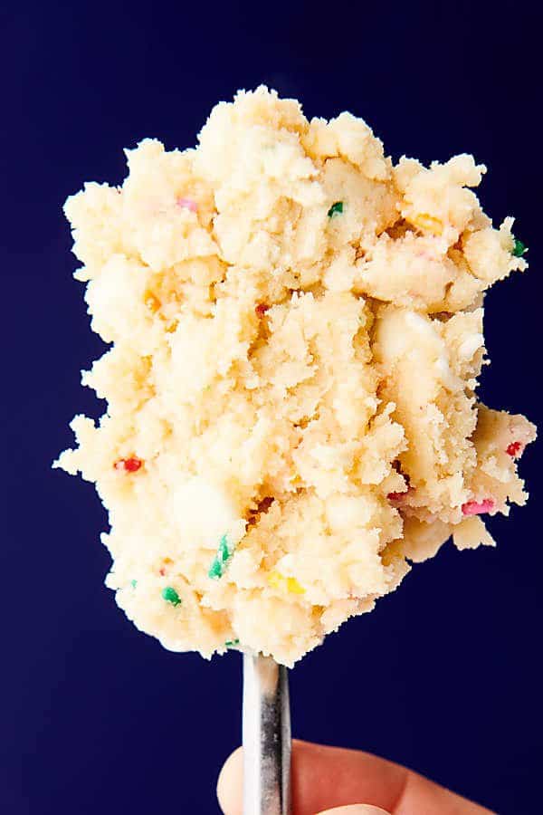 spoonful of edible sugar cookie dough held 