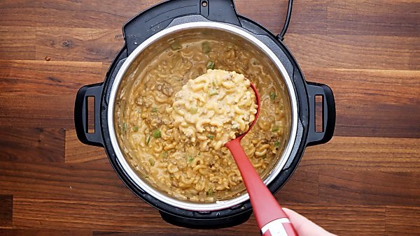 finished instant pot hamburger helper being scooped with ladle