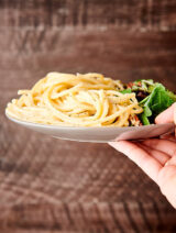 plate of cacio e pepe held