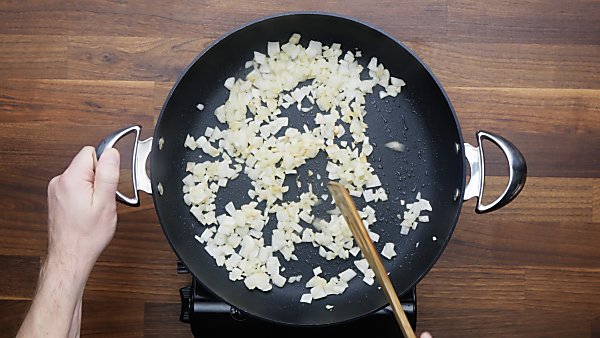 onions being cooked in skillet