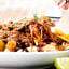 forkful of ropa vieja being lifted off plate