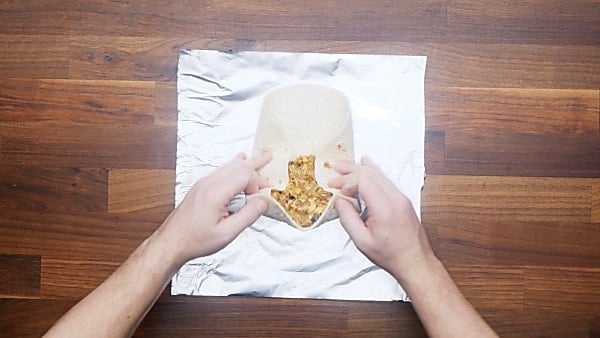 breakfast burrito being rolled