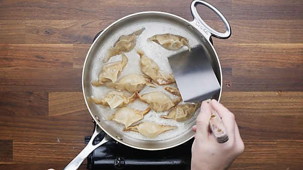 finished potstickers in saute pan
