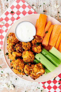plate of air fryer buffalo cauliflower, celery, and carrots with ranch dressing