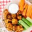 plate of air fryer buffalo cauliflower, celery, and carrots with ranch dressing