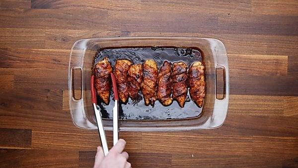 bacon wrapped chicken tenders in baking dish