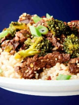 plate of instant pot beef and broccoli over rice held