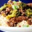 plate of instant pot beef and broccoli over rice held