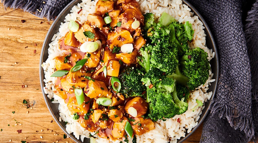 plate of instant pot honey garlic chicken with rice and broccoli above