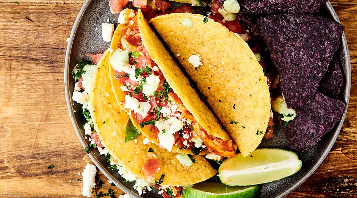 instant pot salsa chicken tacos on plate above
