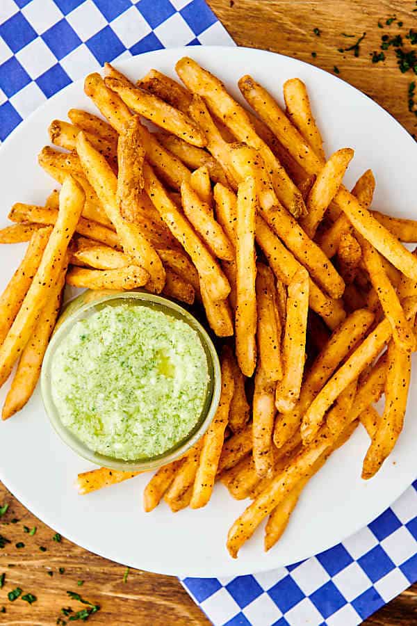 plate of fries with pesto aioli above