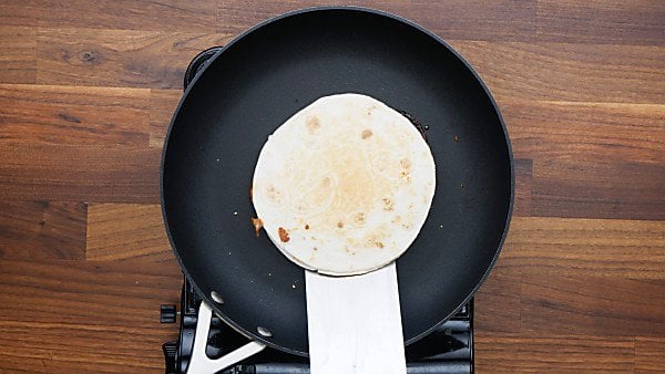 tortilla being cooked in skillet