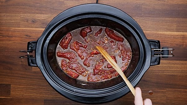 sauce and steak in crockpot