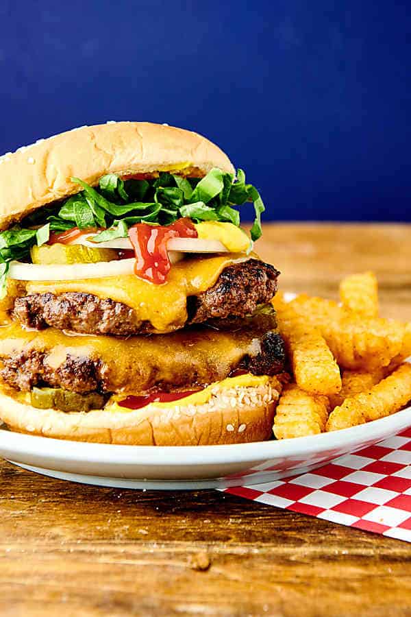 smash burger on plate with fries