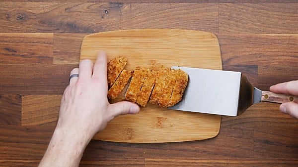sliced pork chop on cutting board