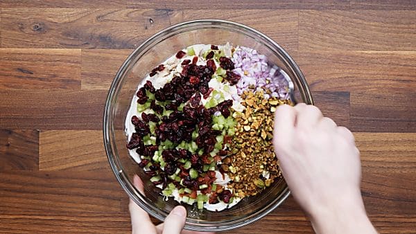 all cranberry chicken salad ingredients in bowl