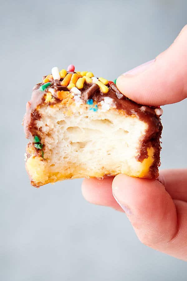 chocolate frosted air fryer donut hole held