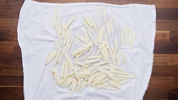 potato slices being dried on towel
