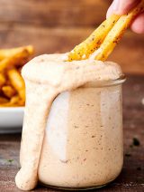 fries dipped in jar of chipotle aioli