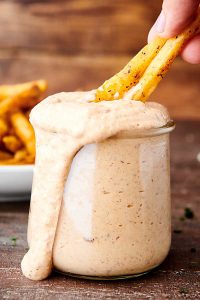 fries dipped in jar of chipotle aioli