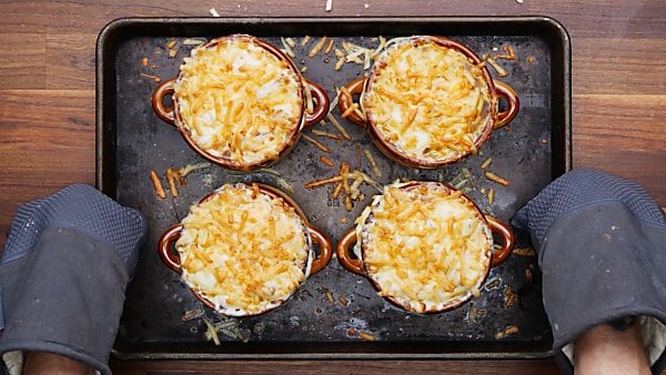 cheese melted over bowls of instant pot french onion soup
