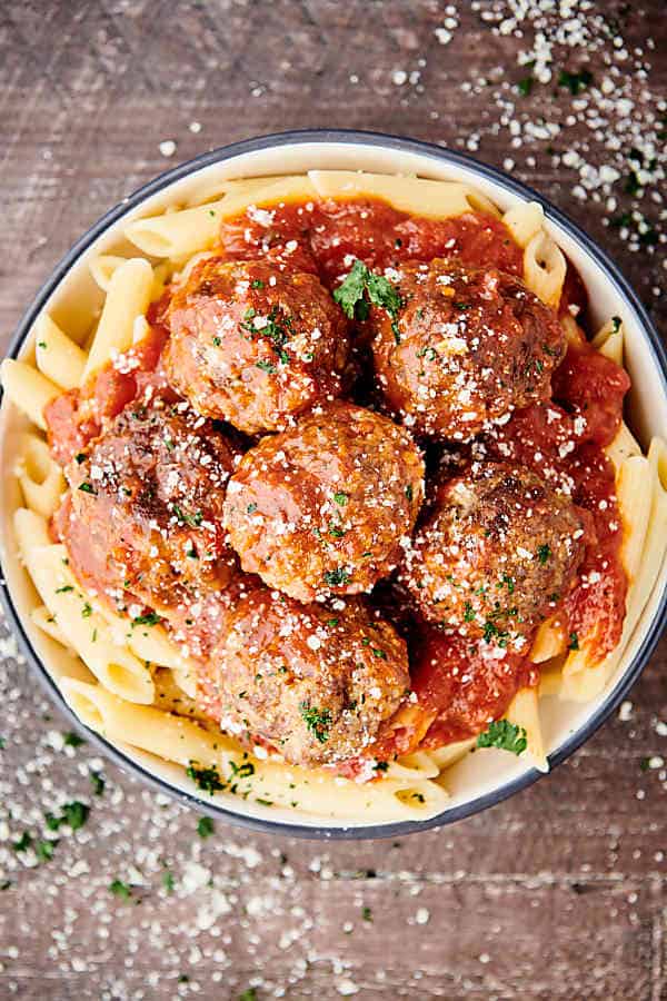 spaghetti and marinara topped with instant pot meatballs above