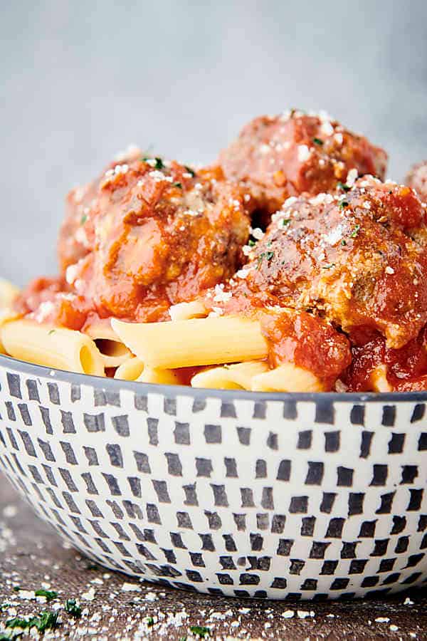 side view bowl of pasta with red sauce and instant pot meatballs
